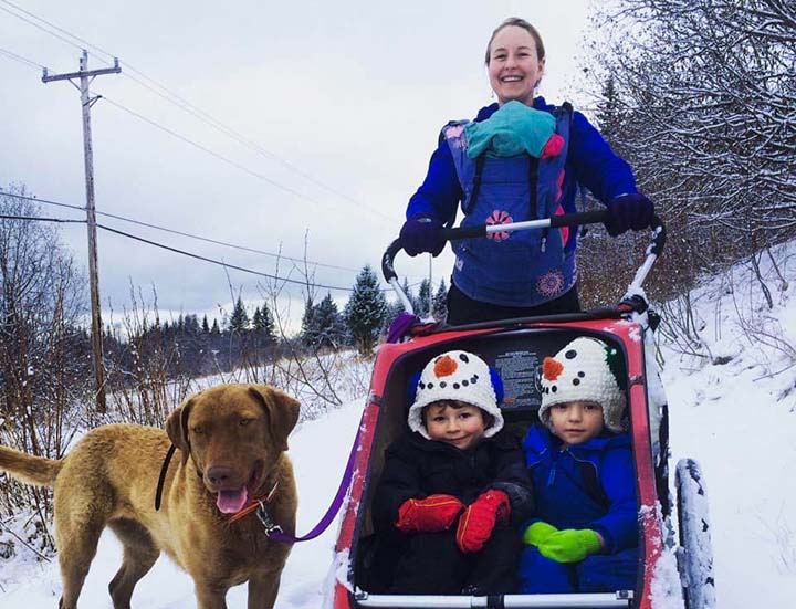 family walking in the winter with dog